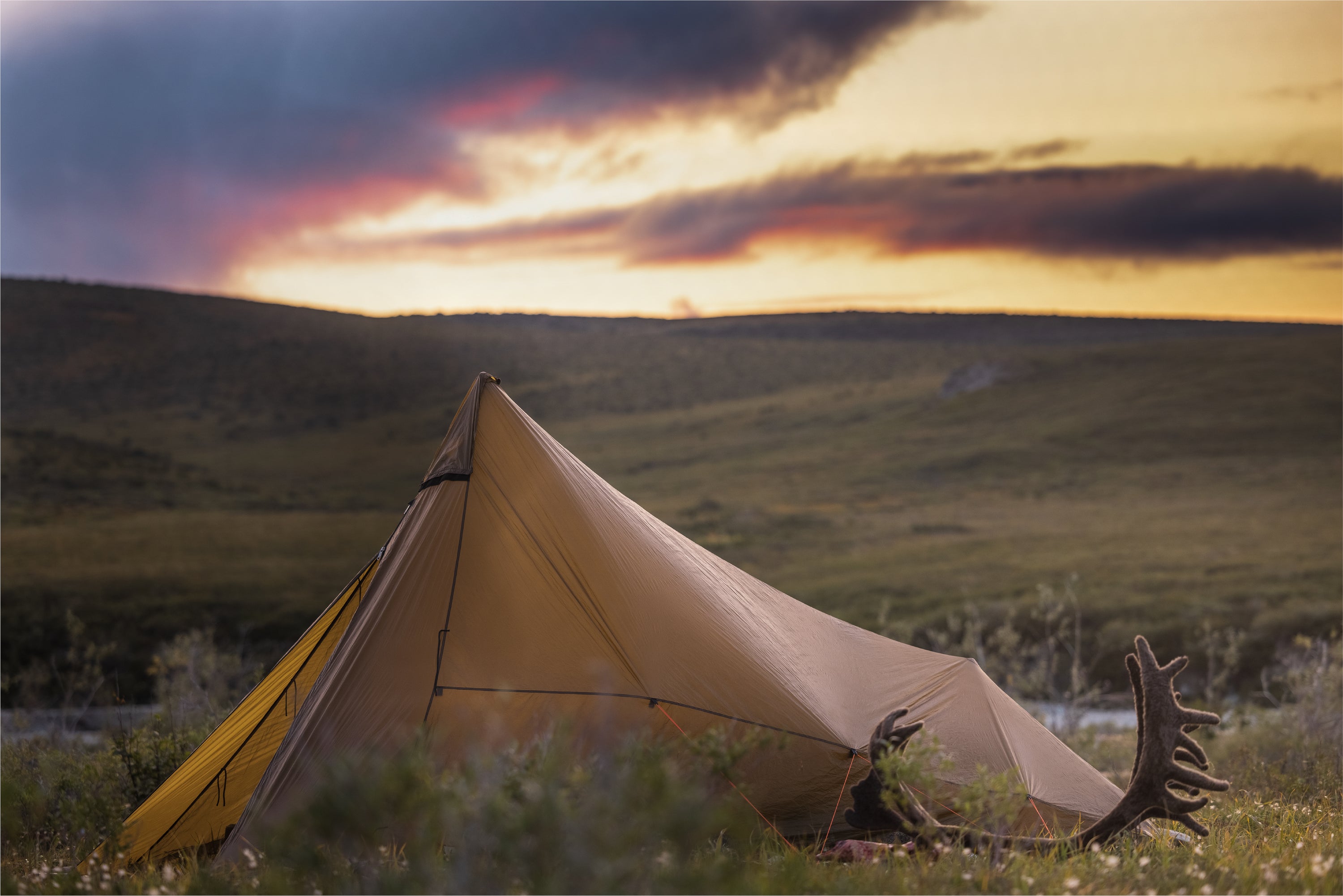 A tent and horn with a full view of sunset
