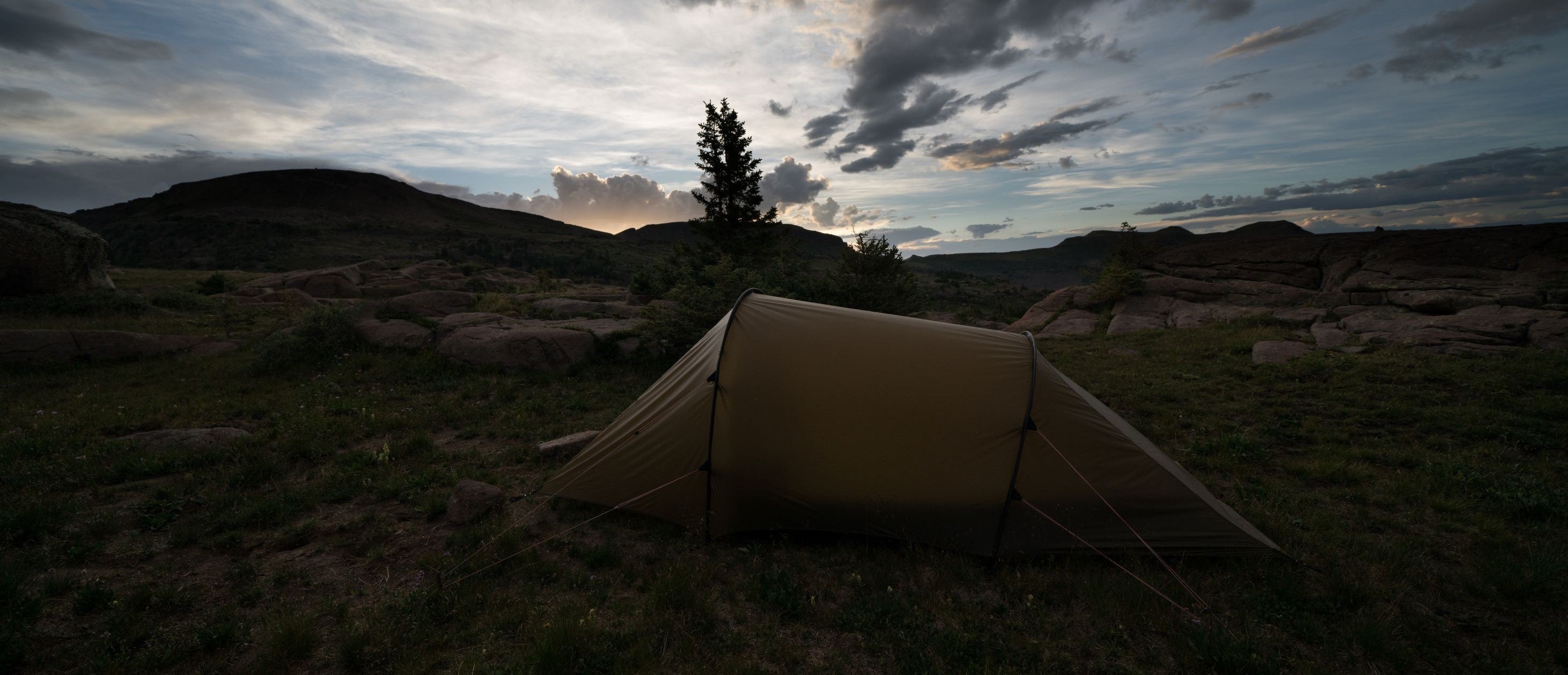 A full view of a tent with a full view of sunrise