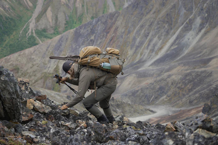 A photo of a woman hiking in a very dangerous rocks